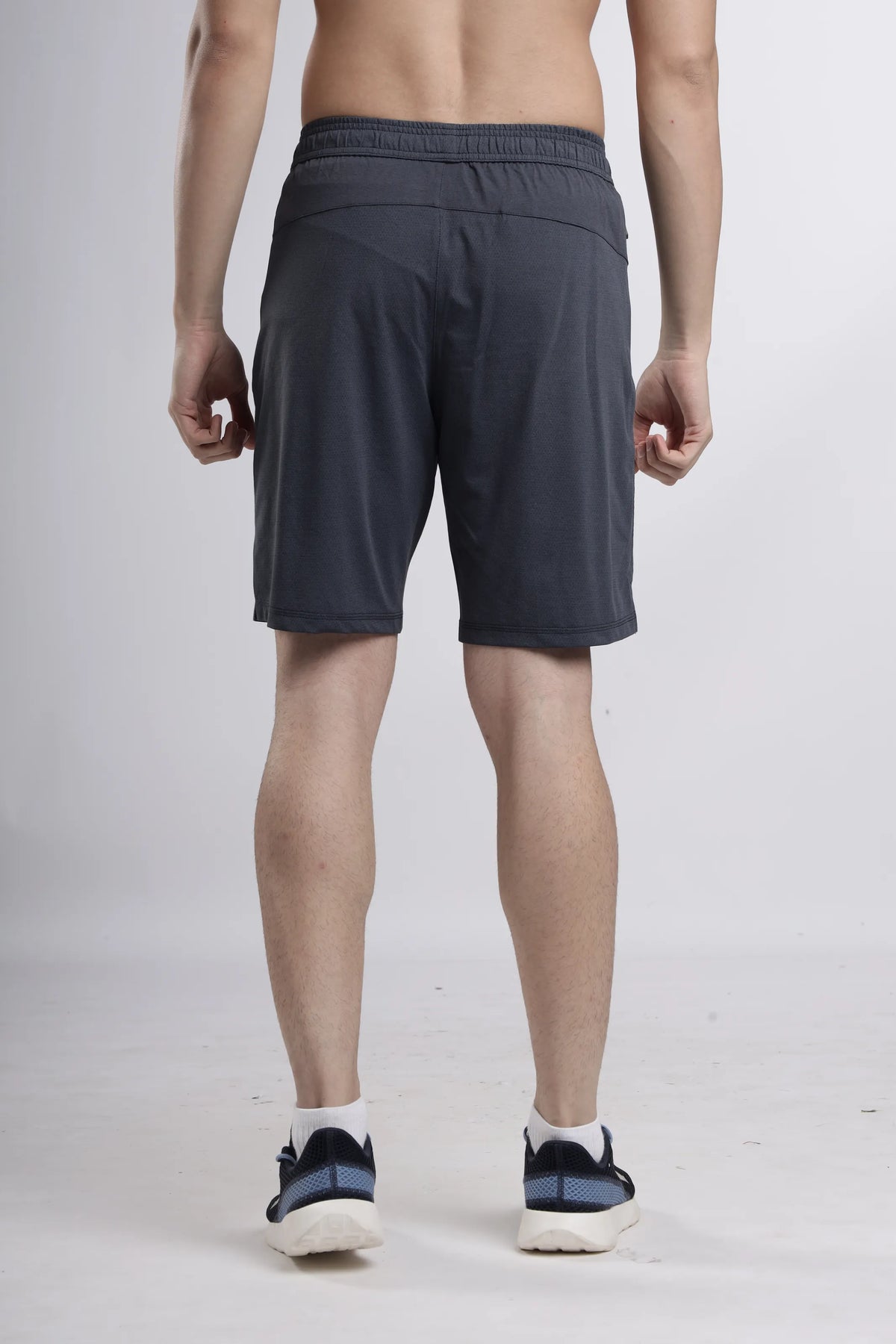 AirWave Performance Shorts in dark grey, back view on a model
