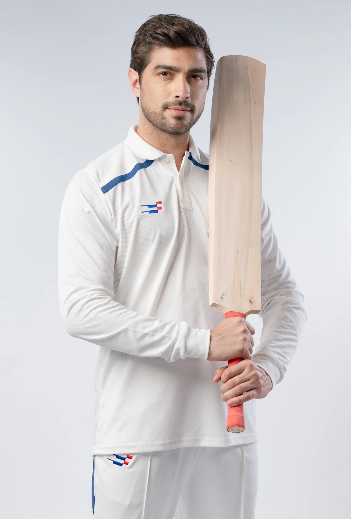 Bouncer Cricket Whites T-Shirt in white full sleeve, worn by a model holding a cricket bat