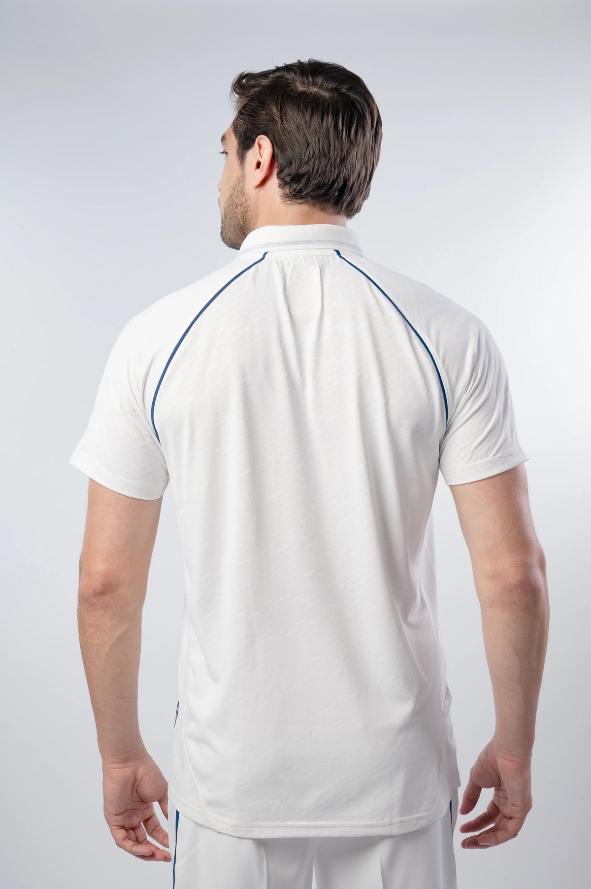 Cobra-Pro Cricket Whites T-Shirt in white, back view with blue piping across the shoulders