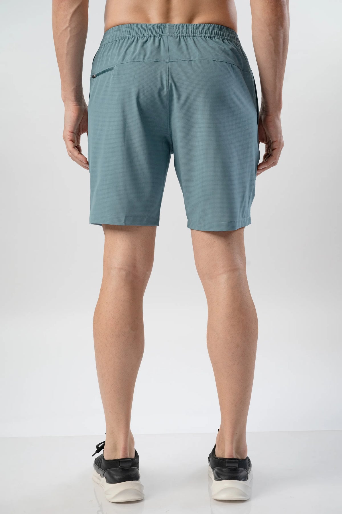 Fast-Track Running Shorts in hunter, back view showing the elastic waistband and a zip back pocket