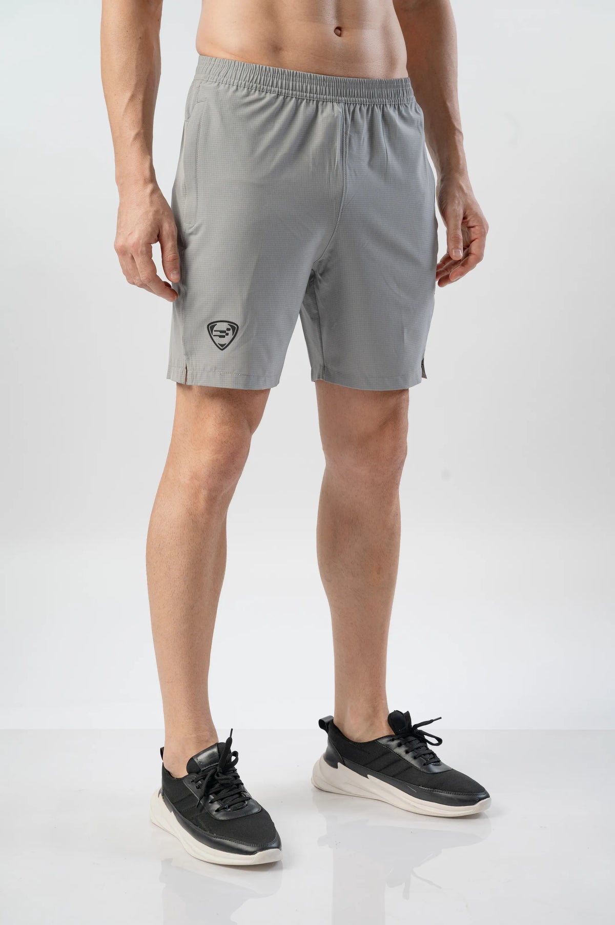 Fast-Track Running Shorts in light lava, three-quarter front view on a model with black trainers