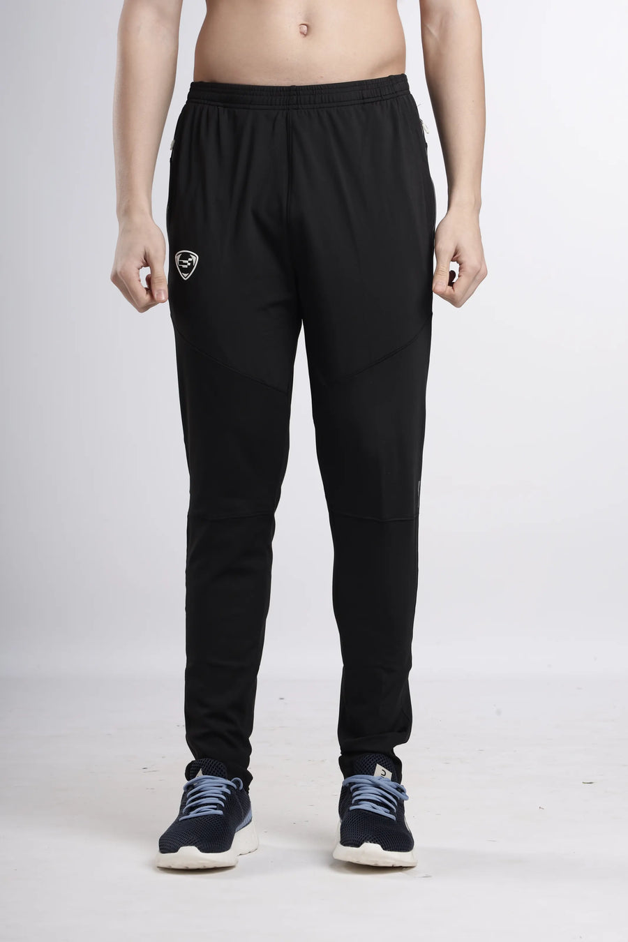 Fire-Bird Signature Track Pant in black, front view on a model showing the tapered leg and shield logo