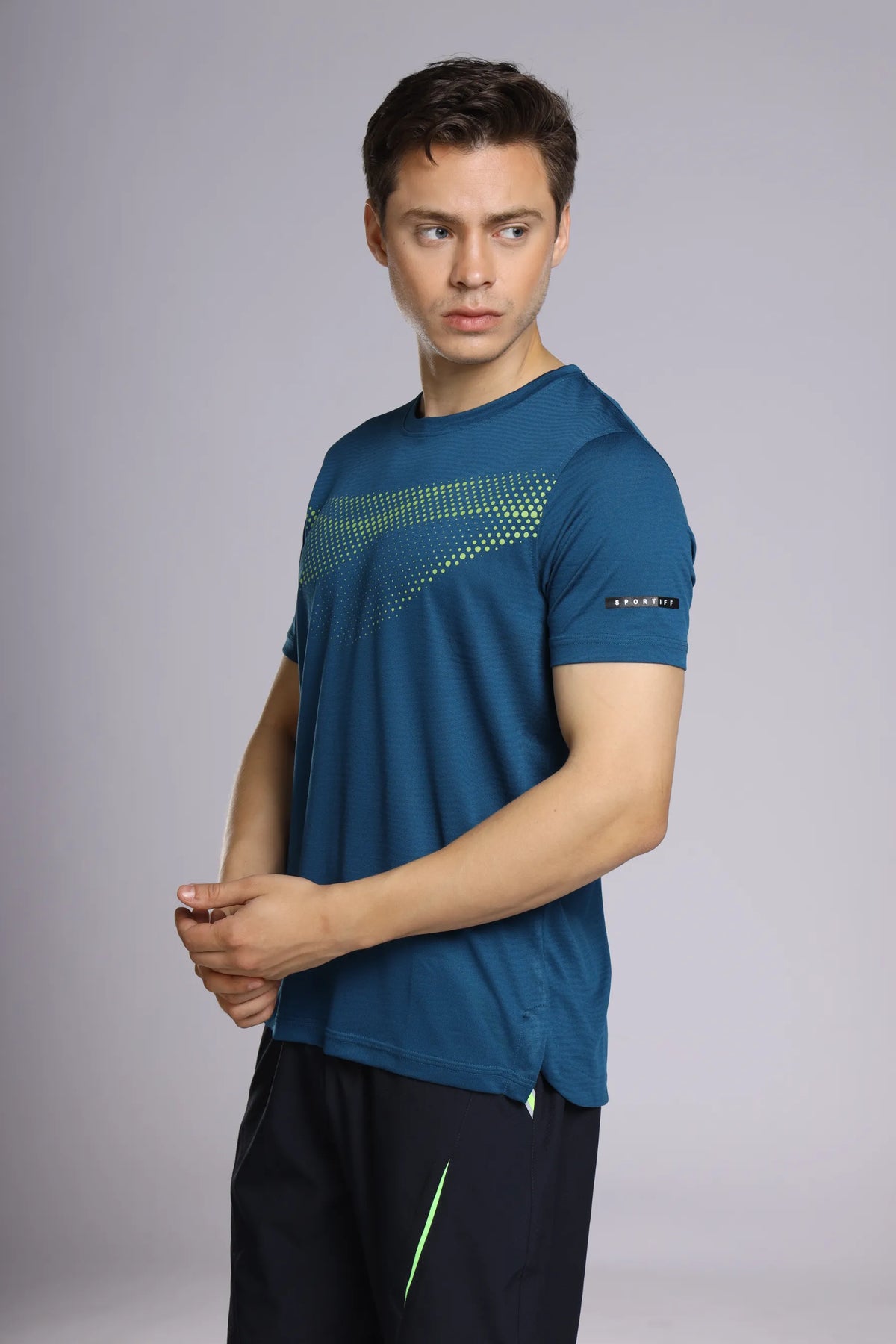 Fit-Gear Core Steel Performance T-Shirt in dark teal, three-quarter view showing the chest graphic and sleeve label