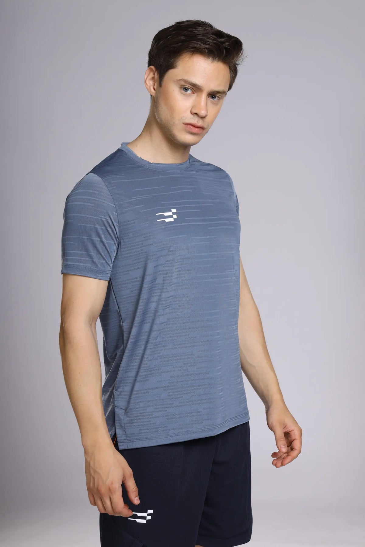 Fit-Gear Iron T-Shirt in mystic blue, angled side view on a model worn with navy shorts