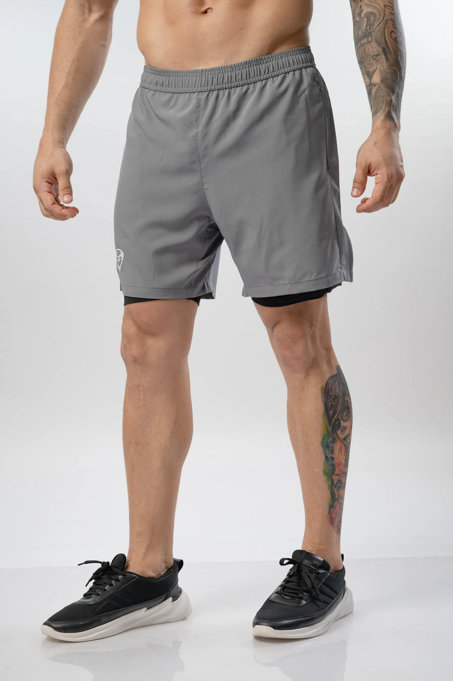 Intense Compression Shorts in grey, front view on a model showing the grey outer short and black inner liner
