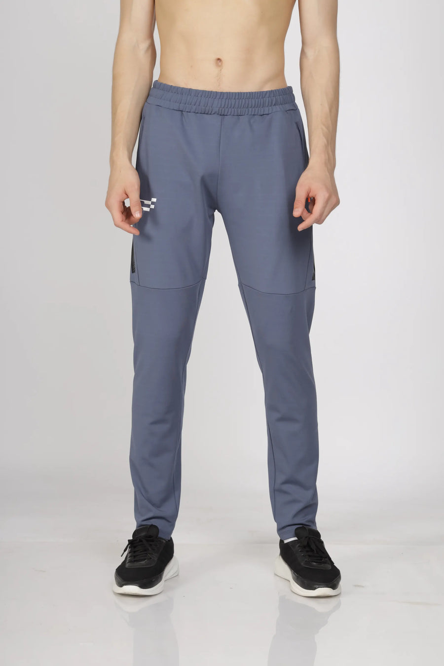 Max-Out Training Track Pant in grey, front view on a model with the logo at the hip