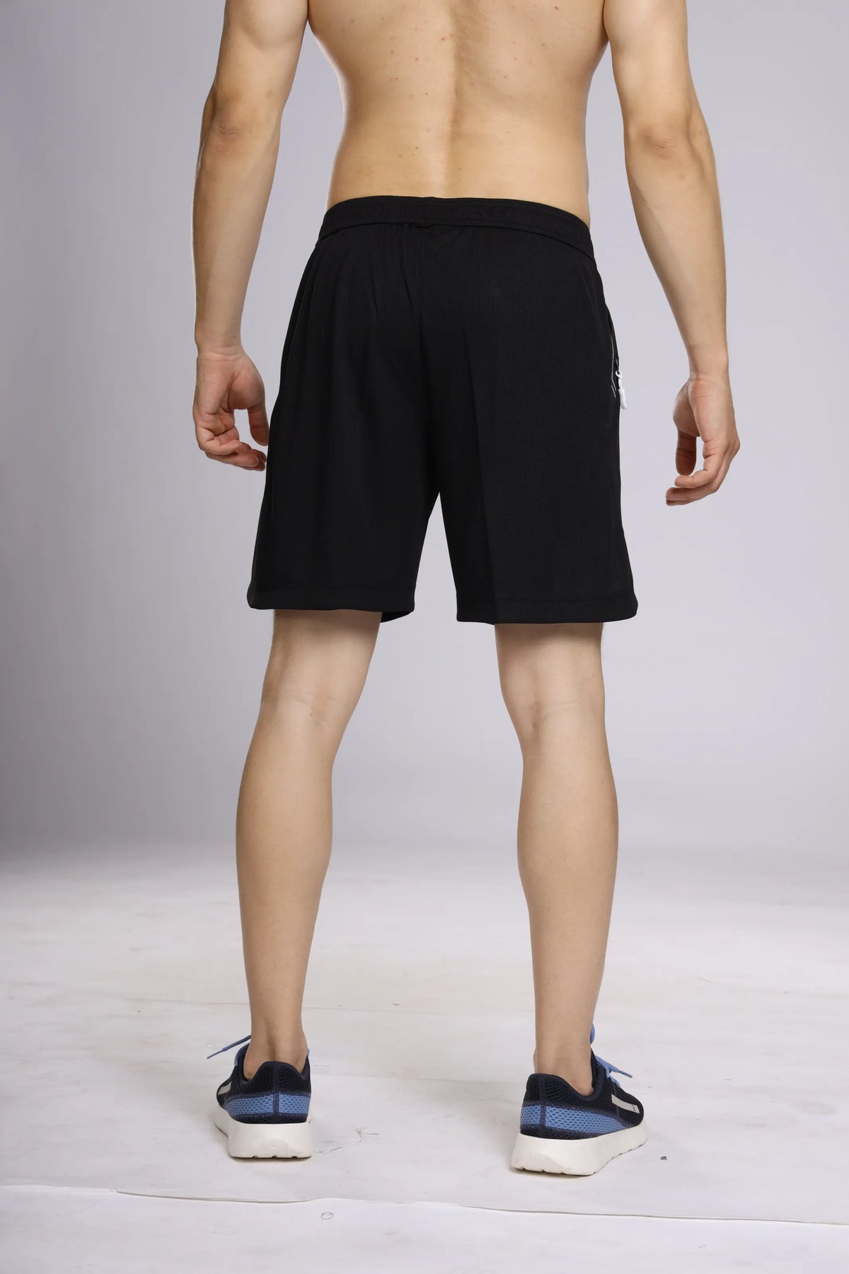 Motion-Tech Running Shorts in black, back view on a model