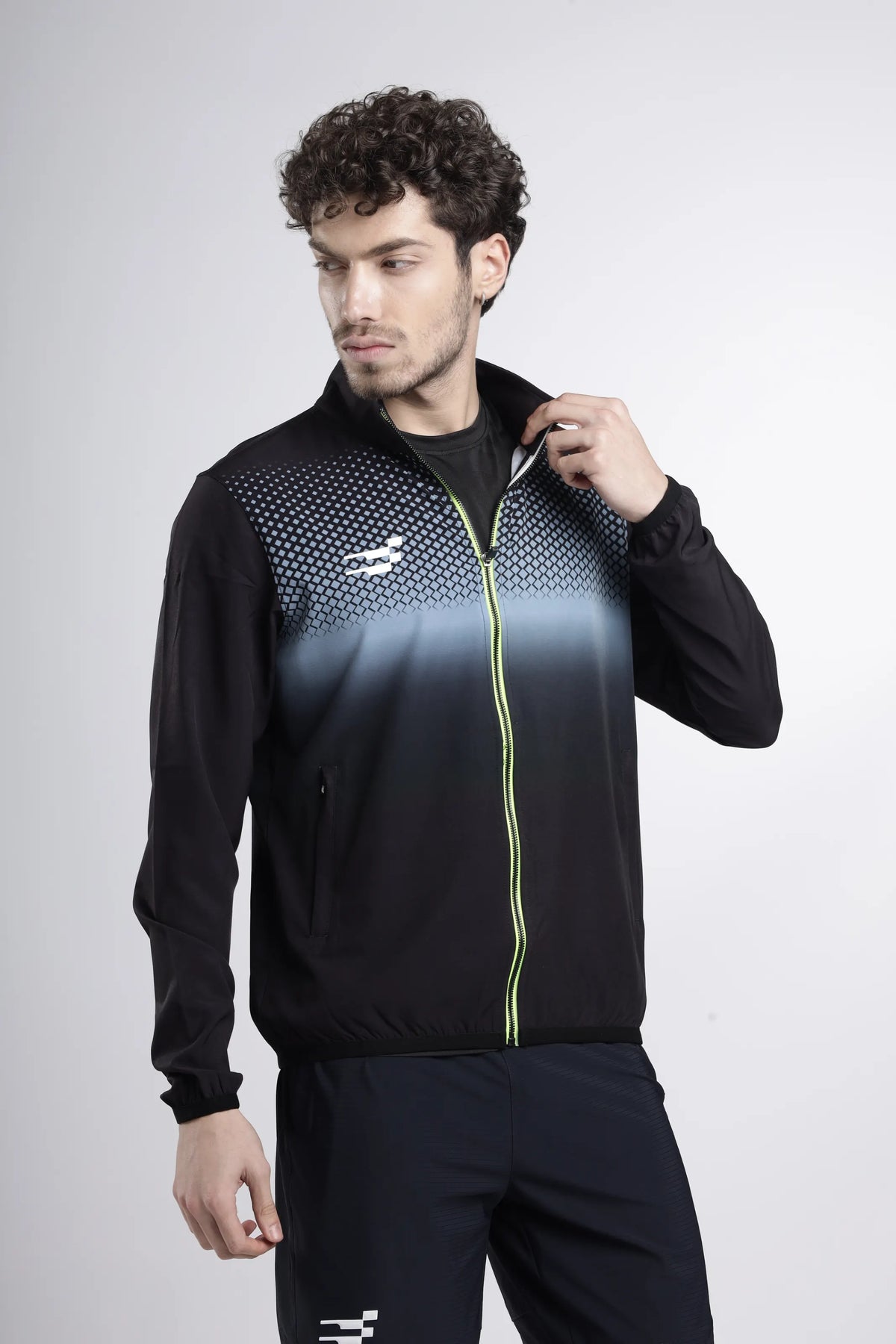Nano-Shell Lightweight Performance Track Top in black, side view with the model adjusting the zipped stand collar