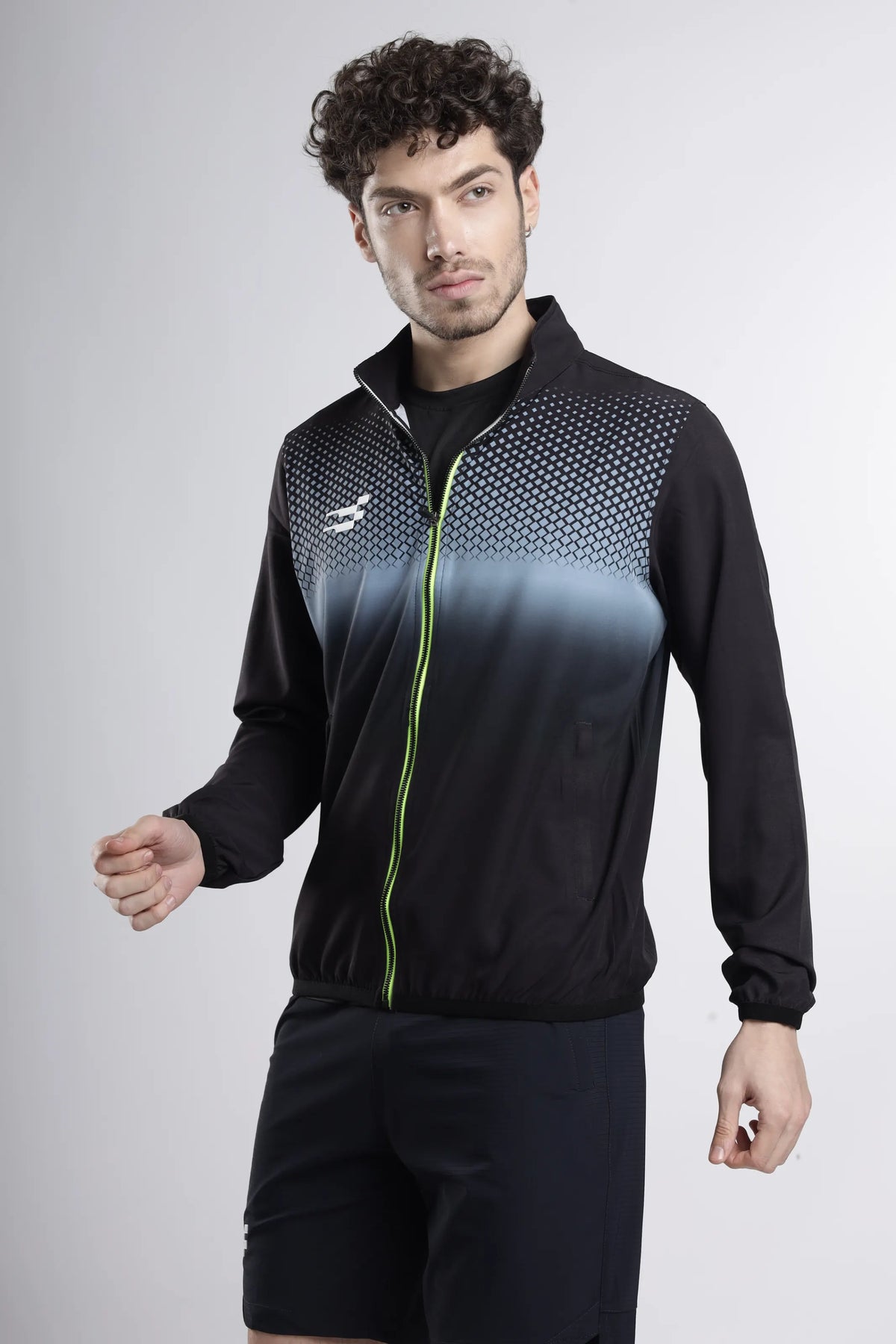 Nano-Shell Lightweight Performance Track Top in black, three-quarter front view with dotted gradient and lime zip