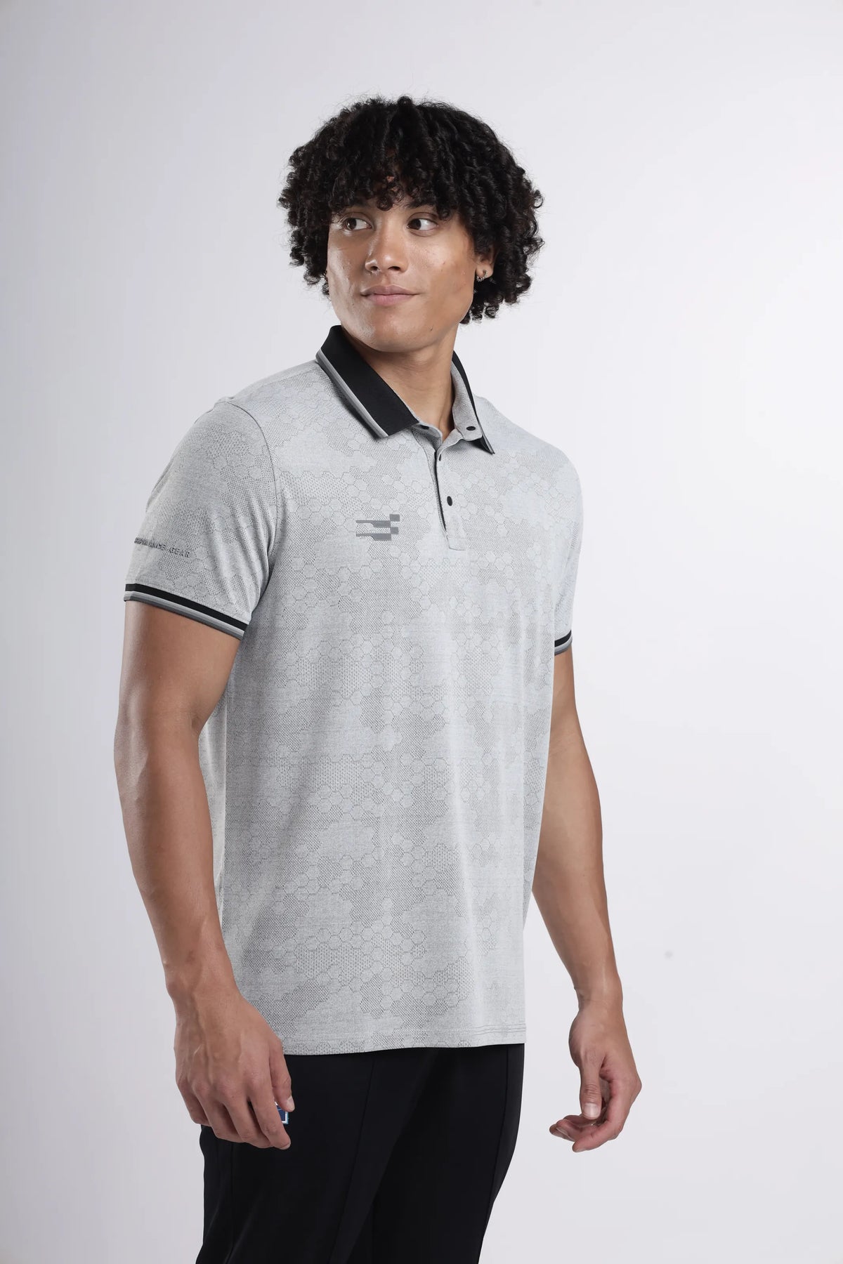 Octagon Performance Polo T-Shirt in light grey, three-quarter view on a model with a black collar and striped sleeve cuffs