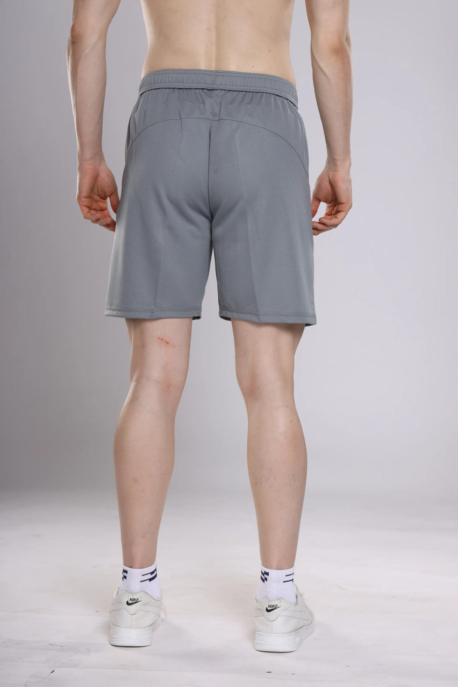 Pro-Gear Performance Shorts in grey, back view showing the curved panel seam