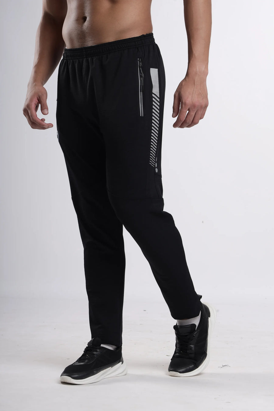 Python Pro-Motion Track Pant in black, three-quarter front view showing the side stripe and zip pocket