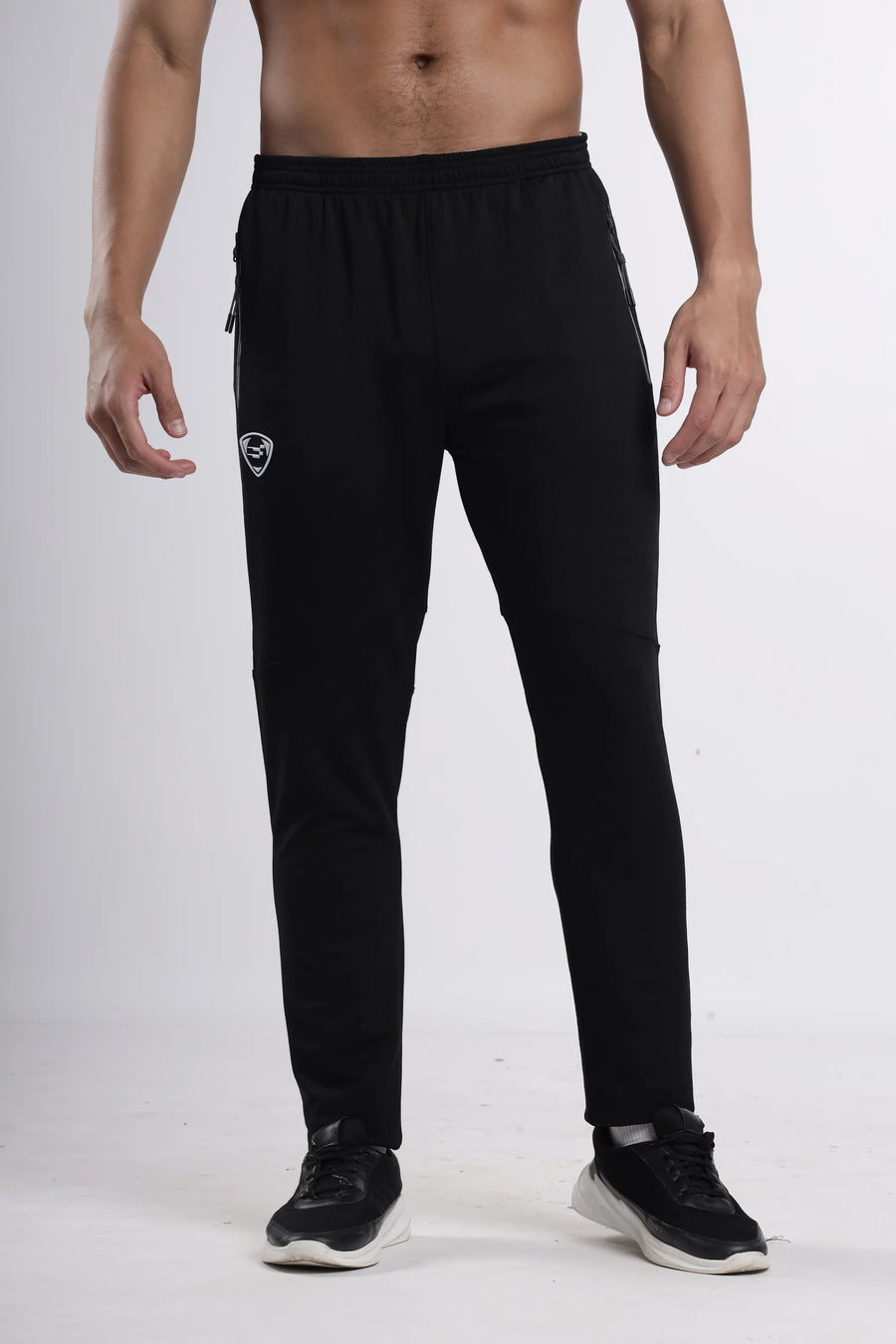 Python Pro-Motion Track Pant in black, front view on a model with the shield logo at the thigh
