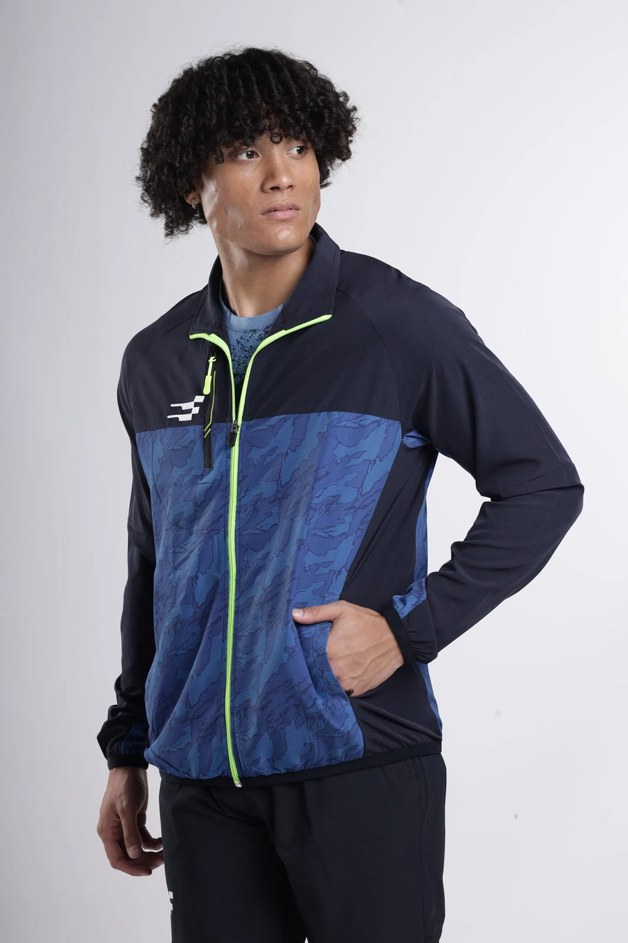 Quantum Performance Track Top in navy, worn by a model with one hand in the side pocket