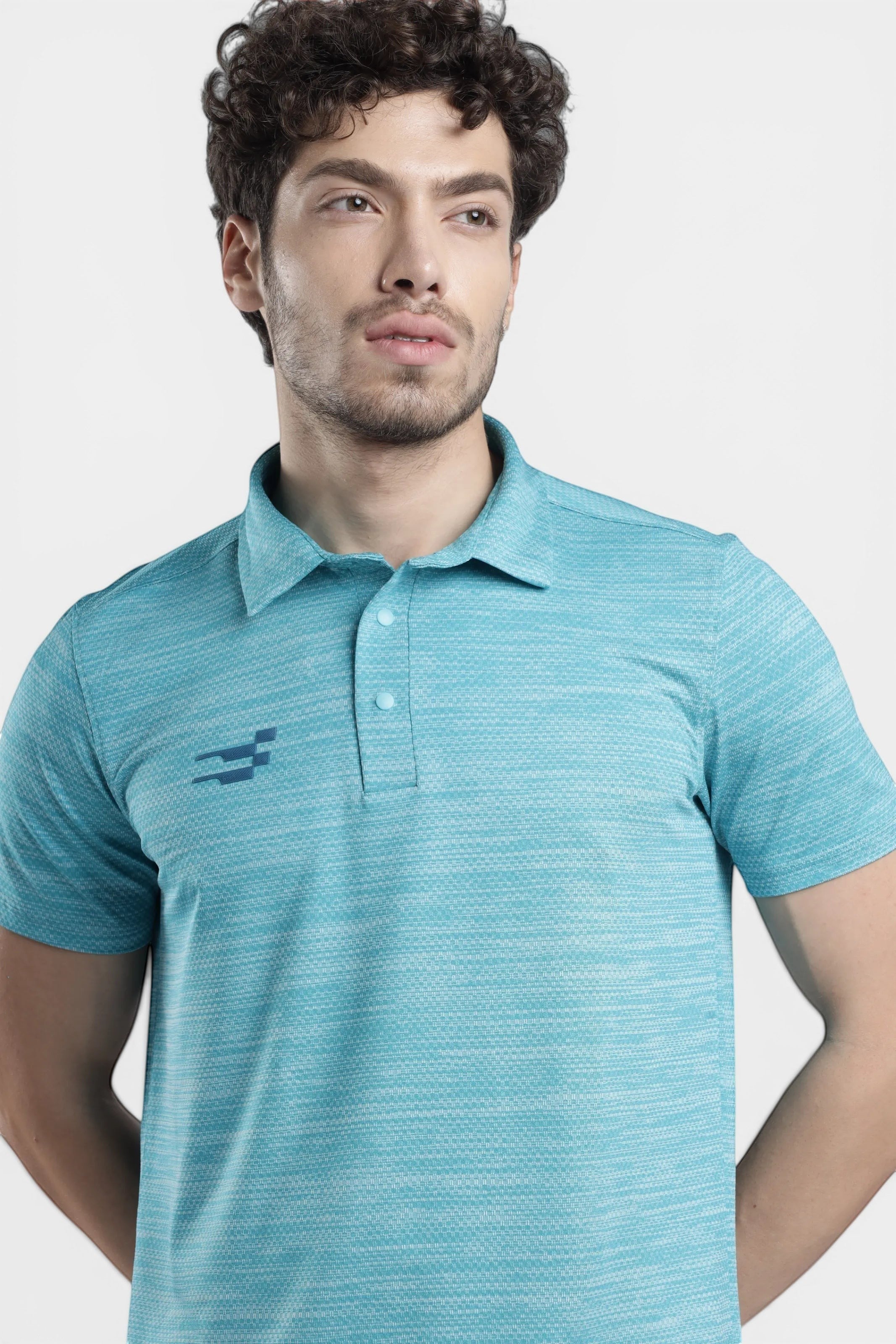 Sportiff Pulseline Performance Polo in scuba blue, featuring a textured jacquard knit fabric and a subtle chest logo. Designed for training and active wear.