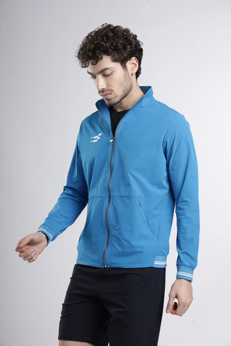 Tech-Shell Performance Track-Top in blue, angled front view showing the zip front, pockets and lime-striped cuffs